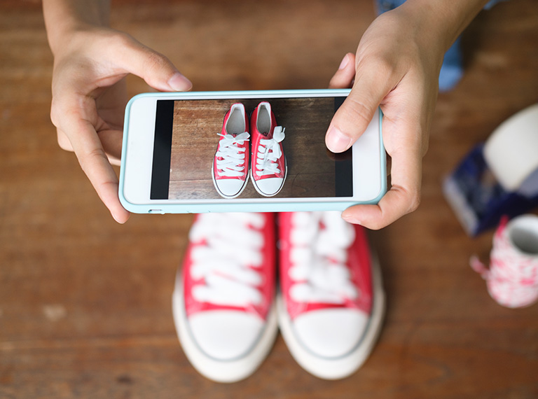 Aerial shot of someone taking a picture of their shoes