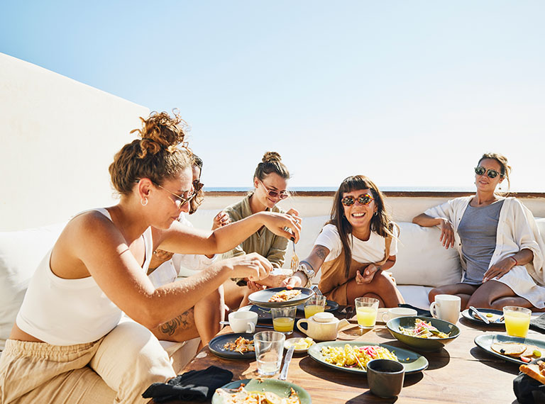 Friends enjoying meal in the outdoors. 