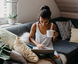 Woman sitting on couch with laptop