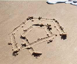 logo drawn in sand