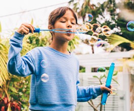 girl blowing bubbles