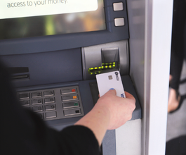 hand putting card into atm