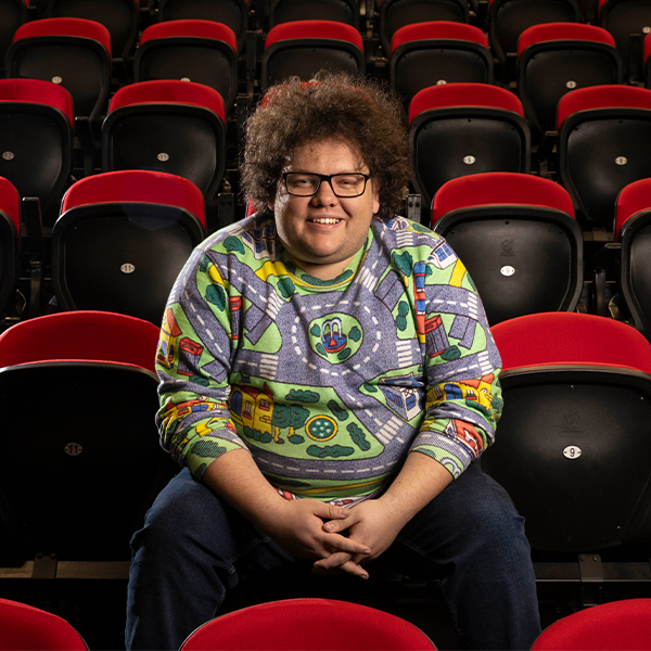 Joshua Maxwell sitting in a theatre