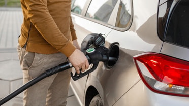 man filling up fuel in his car 