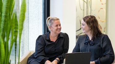 Employees engaging and communicating in a dynamic creative environment.