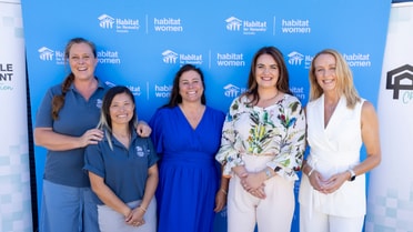 Employees gather behind habitat women and habitat for australia 