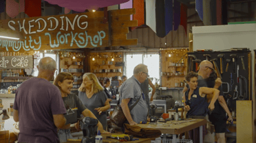 old school style shed with workers and customers browsing 