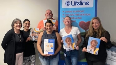Employees posing with lifeline banners