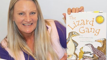 Woman holds a book called 'The Lizard Gang'