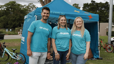 Aruma employees smile and gathered for group photo 