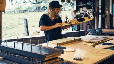 Man making a skateboard in his workshop