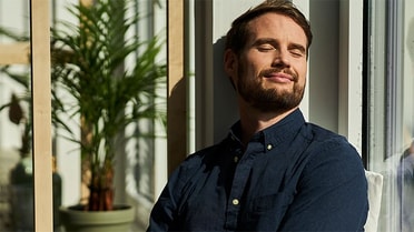 Man standing enjoying sunshine