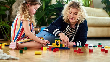 Woman and child play puzzles 