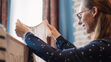 woman looking at a white dress 