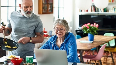 Couple on laptop in kitchen