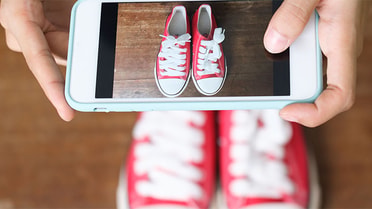 taking a picture on iphone of shoes