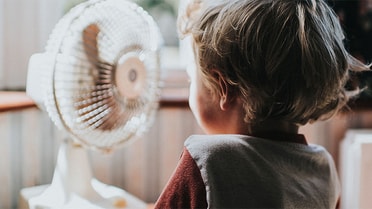 baby in front of fan