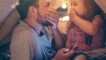 Dad and daughter in play tent