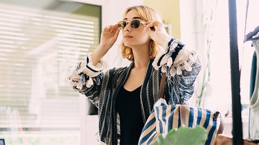 Woman trying on sunglasses in shop