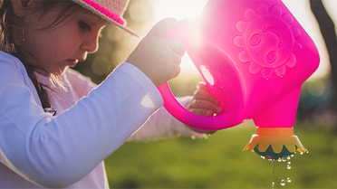 Girl holding watering can