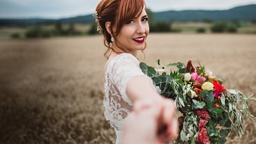 bride in field with flowers