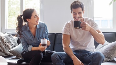 Couple enjoying coffee on couch