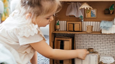 Child playing in doll house