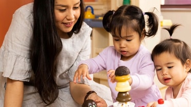 Mother playing with two children playing games
