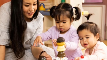 Mother playing with two children playing games