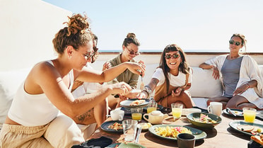 Five women enjoying lunch outdoors