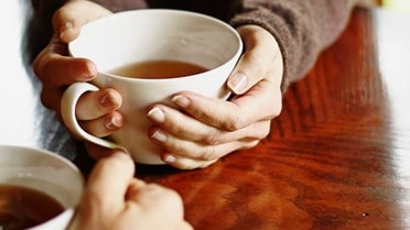 Woman holding coffee cup 