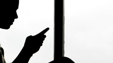 Shadow of a man on his phone 
