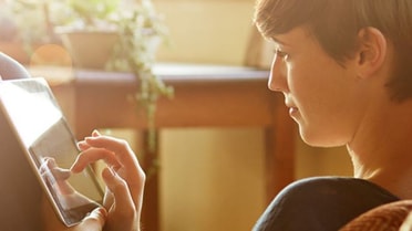 Woman tapping on her tablet 