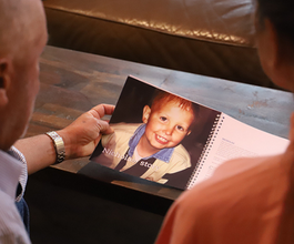 Grandparents looking at phot of grandson