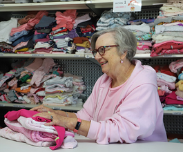 Volunteer packing bundles for families in need.