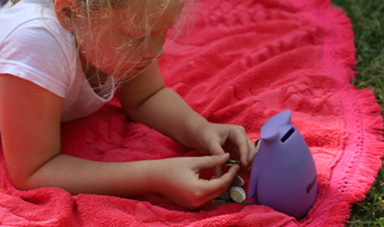Child with piggy bank and pocket money