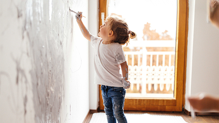 Child painting on wall