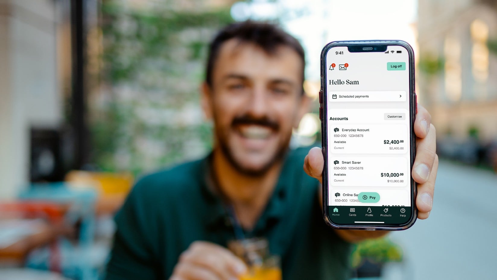 Man holding Newcastle Permanent's top rate app on her mobile phone.
