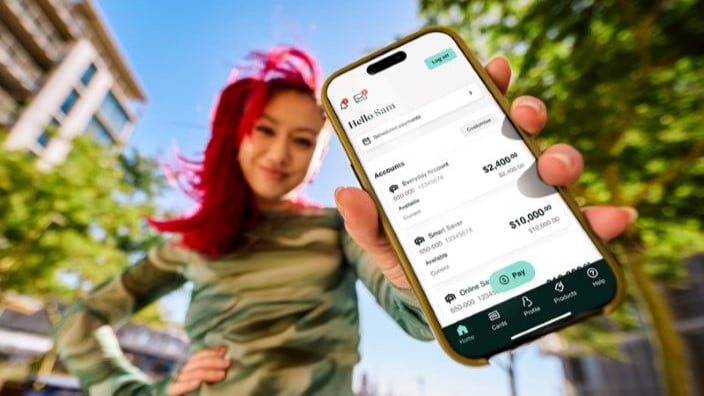 Woman holding Newcastle Permanent's top rate app on her mobile phone.